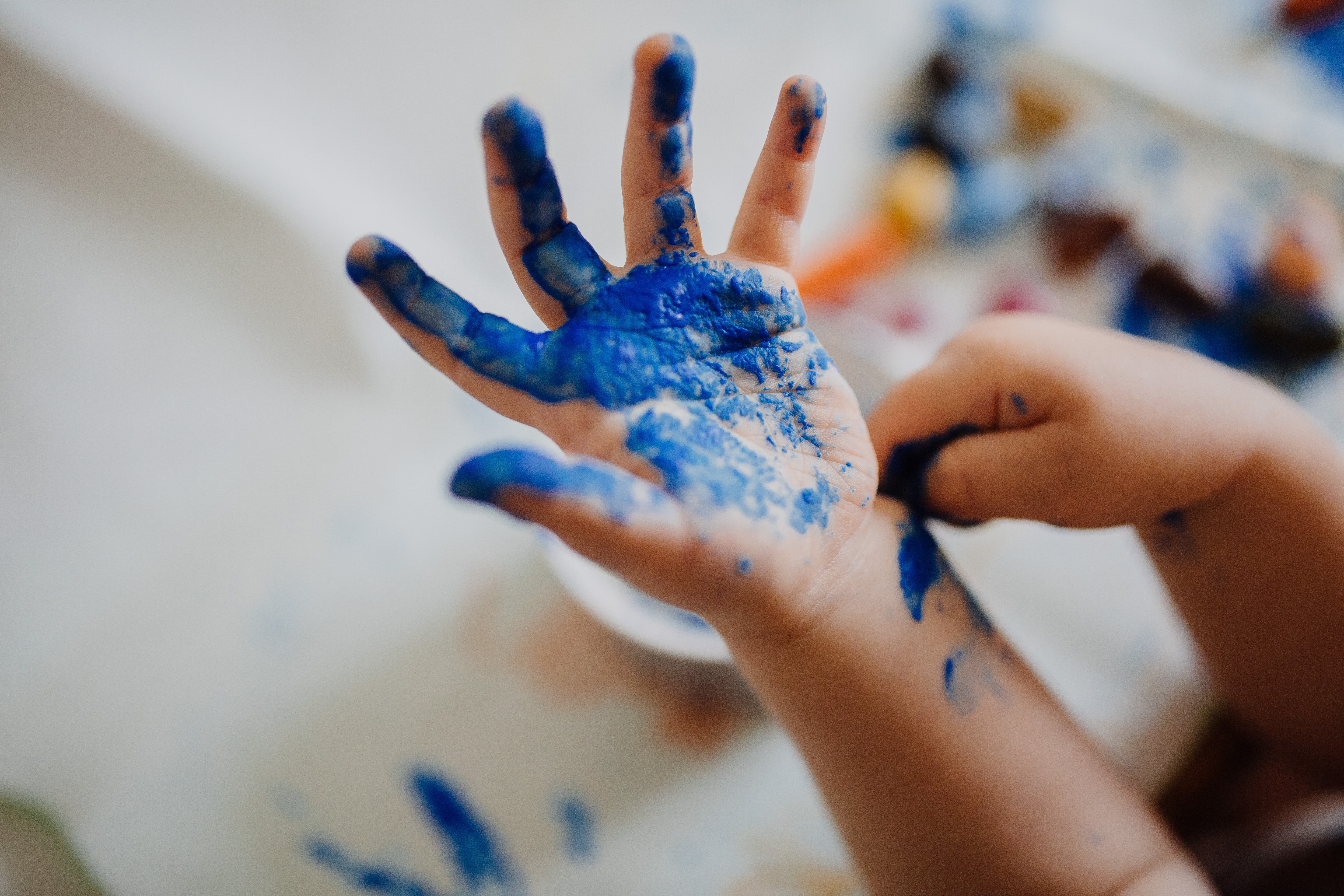 child's hand with blue paint